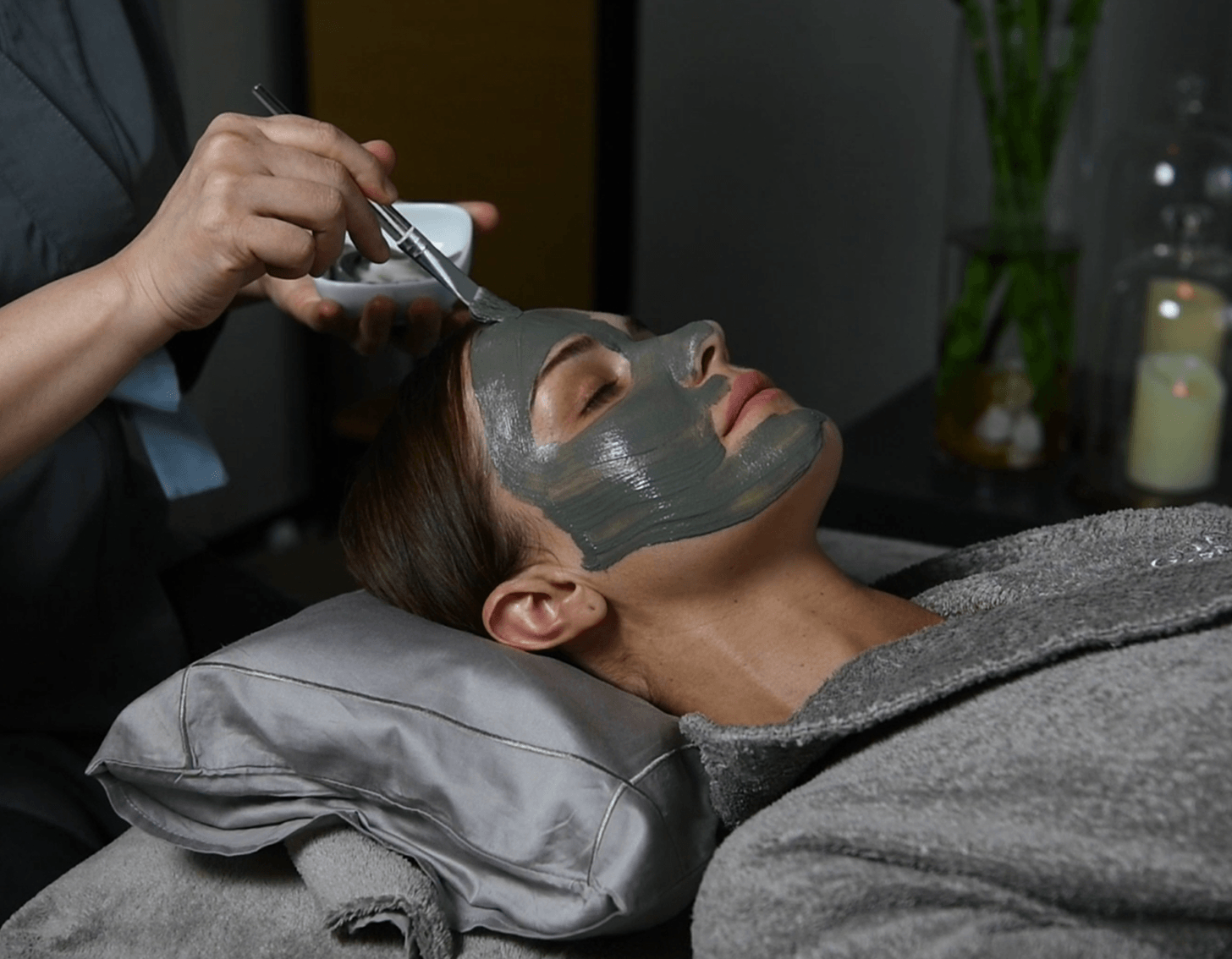 Applying volcanic mud face mask